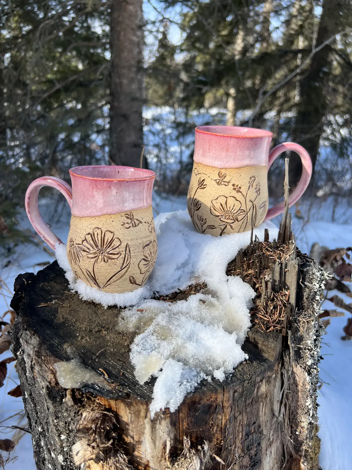 A collection nof handmade pottery mugs.