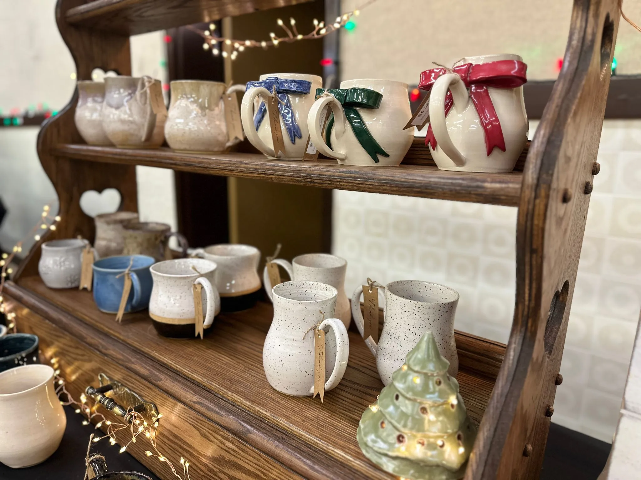 A collection of designer, handmade pottery products on display at a market.