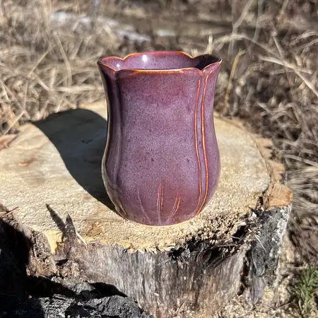 Hand thrown carved tulip cup with purple and green glazes. 