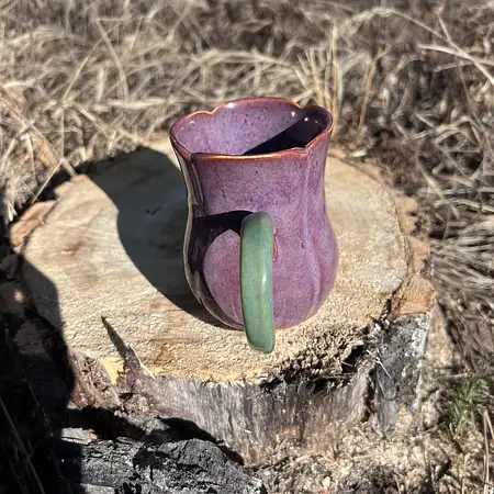 Hand thrown carved tulip cup with purple and green glazes. 