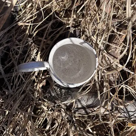 Hand thrown cup dipped in a simple white glaze, making the speckled clay the star of the show. 