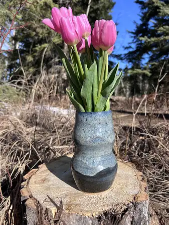 Hand thrown curvy vase with deep blue glazes