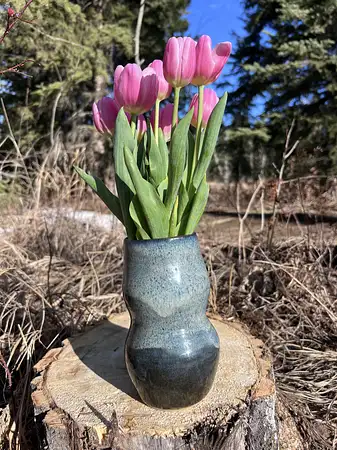 Hand thrown curvy vase with deep blue glazes