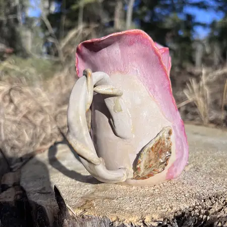 Wheel thrown cup featuring sculpted clay to add unique detail to every rosebud cup.